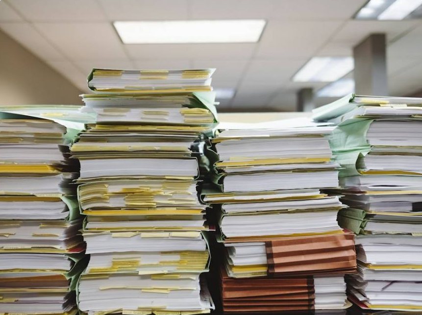 Stacks of paper records and files in an office