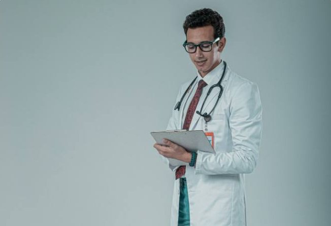 A clinician reviewing notes on a clipboard